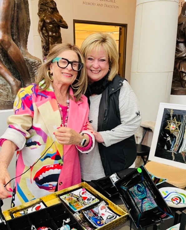 Cheri Toll with a collector at her art show booth